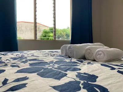 a bedroom with a bed with towels on it at Cata bed & breakfast 2026 in San José