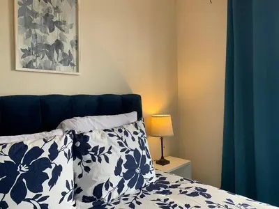 a bedroom with a bed with blue and white pillows at Cata bed & breakfast 2026 in San José