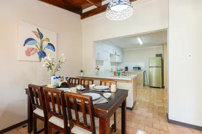 a kitchen and dining room with a table and chairs at Cata bed & breakfast 2026 in San José