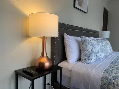 a lamp sitting on a table next to a bed at Cata bed & breakfast 2026 in San José