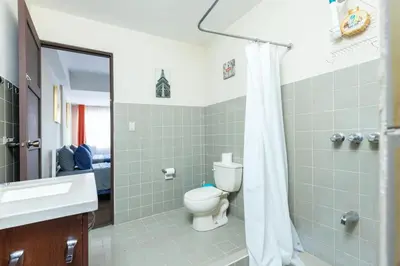 a bathroom with a toilet and a sink and a mirror at Cata bed & breakfast 2026 in San José