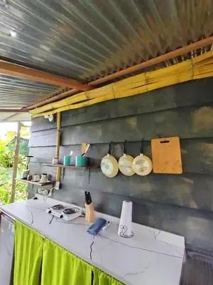 a table with plates on the wall of a kitchen at Arenal Rainforest # La cabaña in Palma