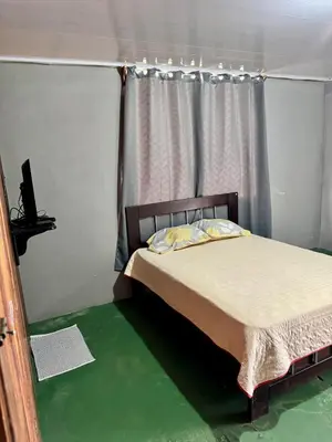 a bedroom with a bed in a room with green floors at Complete house for 6 people in San Isidro