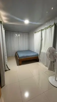 a small room with a bed and a fan at Casa Tano in Delicias