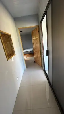 a hallway with doors and a room with a bed at Casa Tano in Delicias