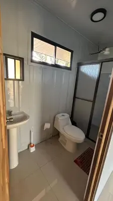 a bathroom with a toilet and a sink at Casa Tano in Delicias