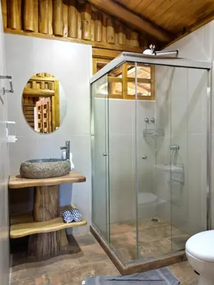 a glass shower in a bathroom with a sink at Cabañas Samara Buenavista in Sámara