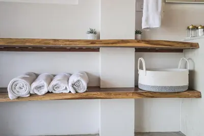 a shelf with towels and a sink in a bathroom at Sunset Villa Uvita - an oceanview 4 bedroom home - no 4x4 needed in Uvita