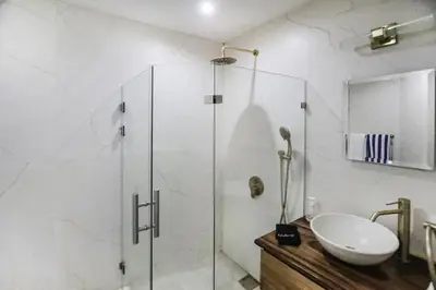 a bathroom with a glass shower and a sink at Sunset Villa Uvita - an oceanview 4 bedroom home - no 4x4 needed in Uvita