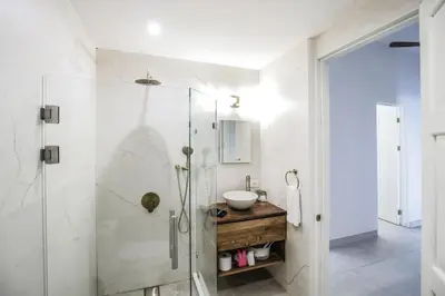a bathroom with a glass shower and a sink at Sunset Villa Uvita - an oceanview 4 bedroom home - no 4x4 needed in Uvita
