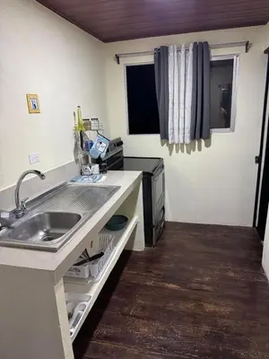 a kitchen with a sink and a counter top at Casa lapas in San Isidro