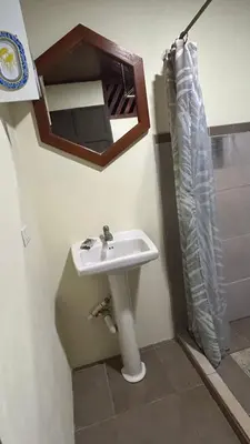 a bathroom with a sink and a mirror at Casa lapas in San Isidro