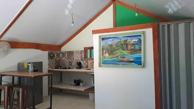 a room with a painting on the wall and a table at Casa AllíS in Cóbano