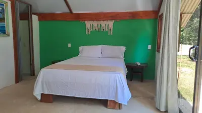 a bed in a room with a green wall at Casa AllíS in Cóbano