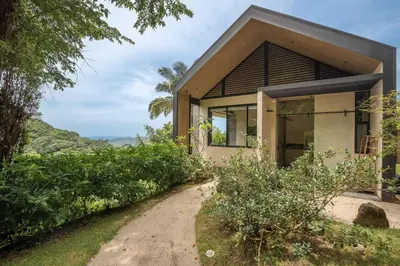 a small house on a hill with a walkway at Steady As We Go in Nosara