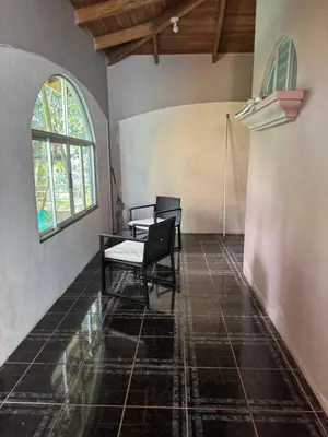 a room with two chairs and a table and a window at Relaxed delfin in Monterrey