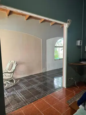 an empty room with a table and a chair at Relaxed delfin in Monterrey
