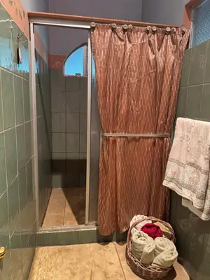 a shower with a glass door in a bathroom at Relaxed delfin in Monterrey