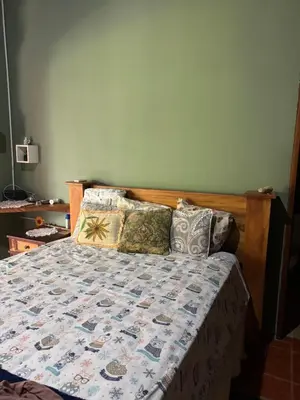 a bedroom with a bed with a quilt and pillows at Relaxed delfin in Monterrey