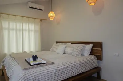 a bedroom with a bed with a tray on it at Cabin Retreat - Nature & Privacy - La Fortuna in Fortuna