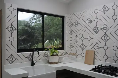 a kitchen with a window and a white counter at Cabin Retreat - Nature & Privacy - La Fortuna in Fortuna