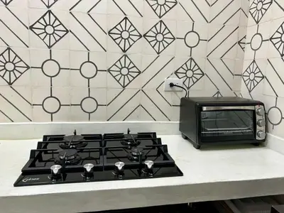 a kitchen with a stove and a microwave at Cabin Retreat - Nature & Privacy - La Fortuna in Fortuna