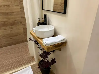 a bathroom with a bowl sink on a wooden shelf at Cabin Retreat - Nature & Privacy - La Fortuna in Fortuna