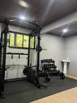 a room with a gym with a bunch of weights at Quiet Miravalles Volcano Farm House with Pool in Bagaces