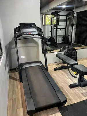 a gym with a treadmill and two exercise bikes at Quiet Miravalles Volcano Farm House with Pool in Bagaces
