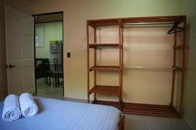 a bedroom with a bed and a book shelf at Santa Teresa Apartments CR in Santa Teresa