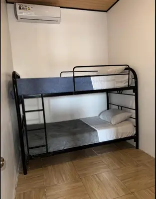 a bedroom with two bunk beds in a room at Santa Teresa Apartments CR in Santa Teresa
