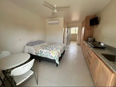 a bedroom with a bed and a table and a sink at Josuary in Brasilito