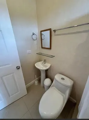 a bathroom with a toilet and a sink at Josuary in Brasilito