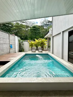 a swimming pool in the backyard of a house at Lumi Vacation Home in Quebrada Ganado