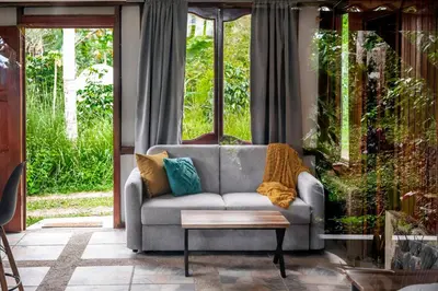 a living room with a couch and a coffee table at Casa Cúrcuma in Turrialba