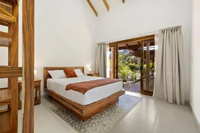 a bedroom with a bed and a sliding glass door at Casa Aves in Santa Cruz