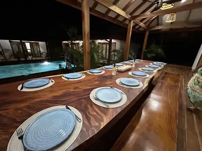 a long wooden table with blue and white plates on it at Casa Aves in Santa Cruz