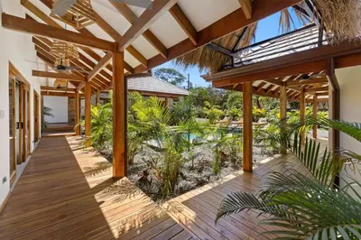 an open porch with a wooden deck with plants at Casa Aves in Santa Cruz