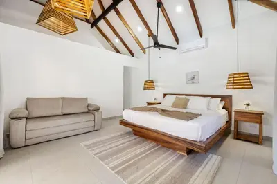 a bedroom with a bed and a chair at Casa Aves in Santa Cruz