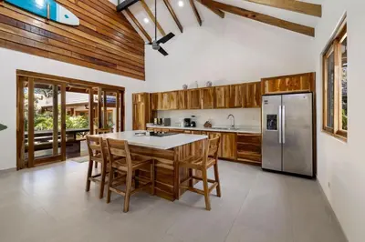 a kitchen with a table and a refrigerator at Casa Aves in Santa Cruz