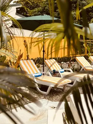 a group of lounge chairs sitting on the beach at Casitas Amarillas in Uvita