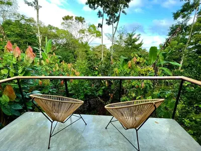 two chairs sitting on top of a balcony at Cabañas Toku Laka in Fortuna