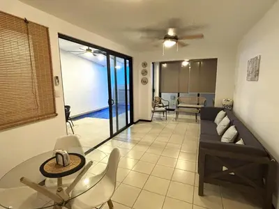 a living room with a couch and a table at Casa Brisamar - House with Private Pool in Herradura