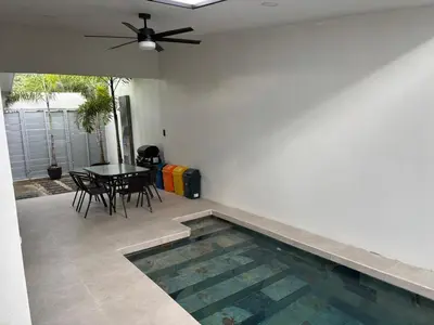 a patio with a table and a swimming pool at Casa Brisamar - House with Private Pool in Herradura