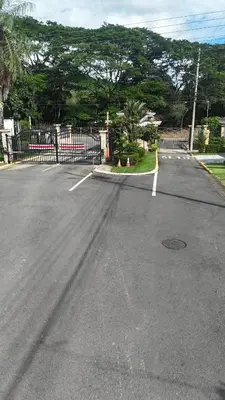 an empty parking lot with a fence and trees at Casa Brisamar - House with Private Pool in Herradura