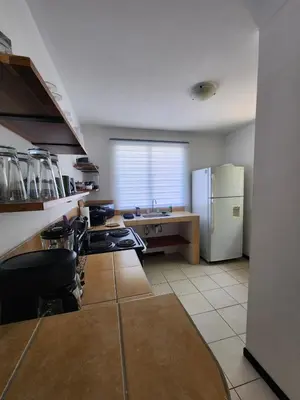 a kitchen with a stove and a refrigerator at Casa Brisamar - House with Private Pool in Herradura