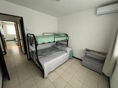 a bedroom with two bunk beds in a room at Casa Brisamar - House with Private Pool in Herradura