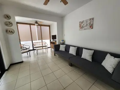 a living room with a couch and a chair at Casa Brisamar - House with Private Pool in Herradura