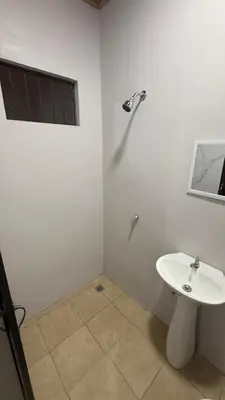 a white bathroom with a sink and a window at Casa Antioquia #6 in Garita