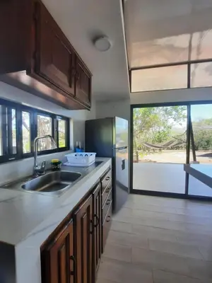 a kitchen with a sink and a large window at Tierra de Gosén in Santa Cruz